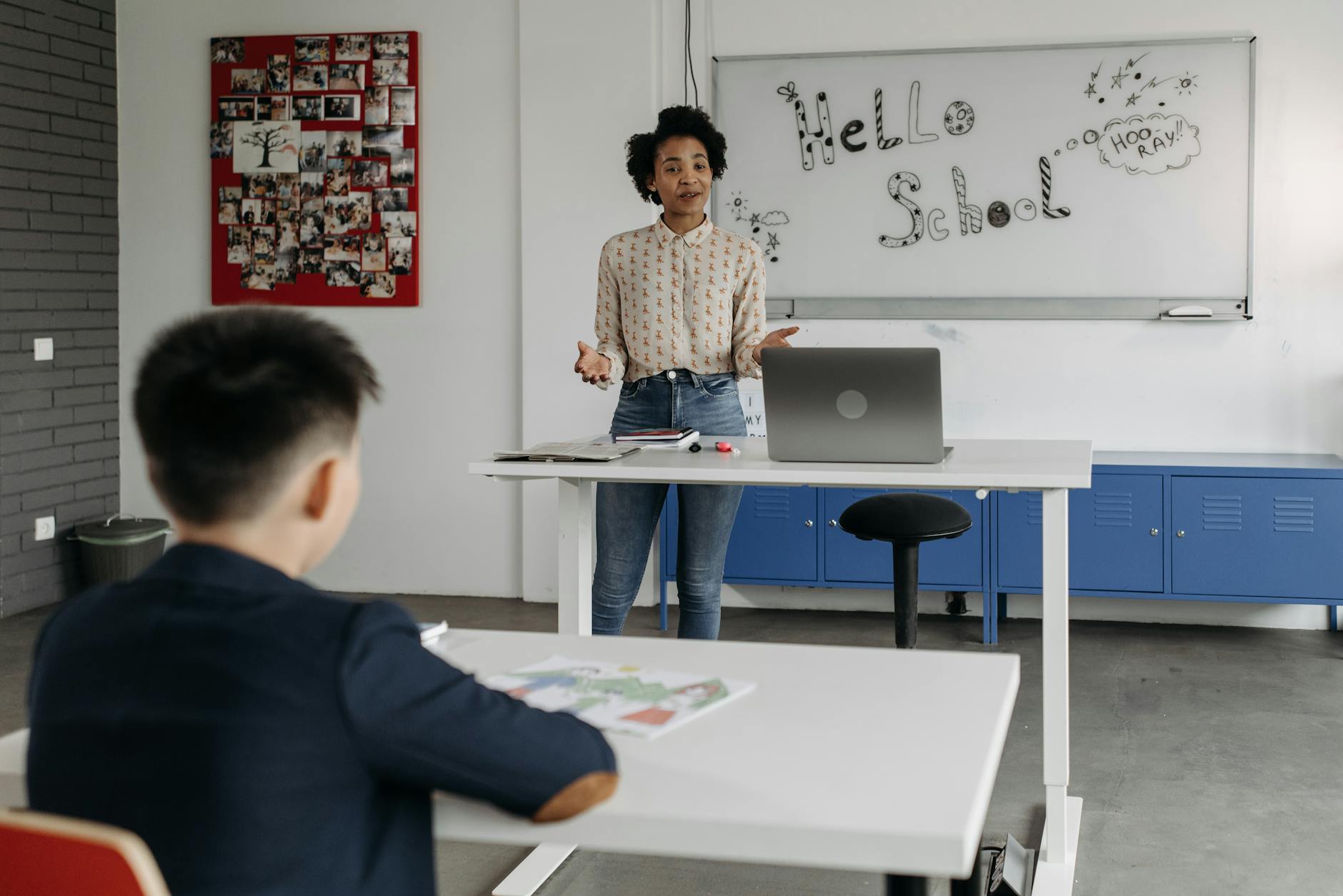 Educator leads interactive lesson in a classroom with a whiteboard display. (Photo by Pavel Danilyuk on Pexels)